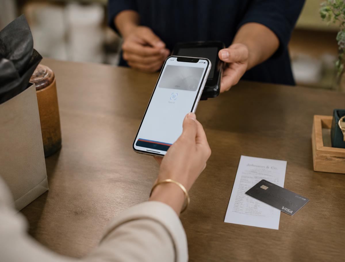 A customer paying at a small retail counter